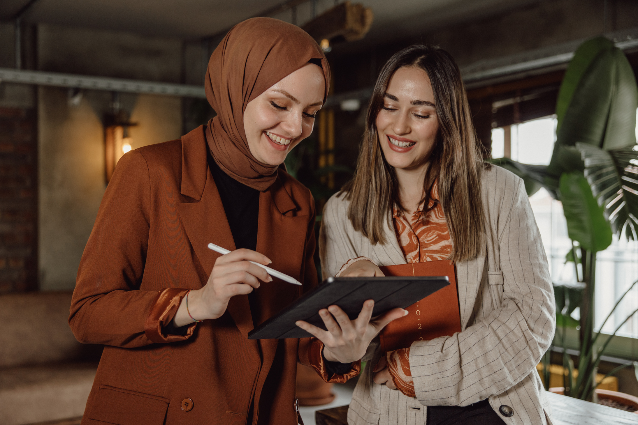 Female Workmates Looking at the Digital Tablet